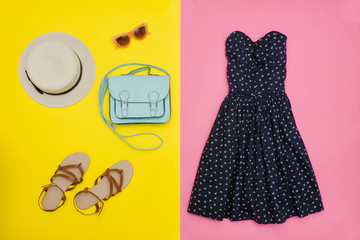Fashionable concept. Female summer wardrobe. Straw hat, sundress, handbag and shoes. Yellow and pink
