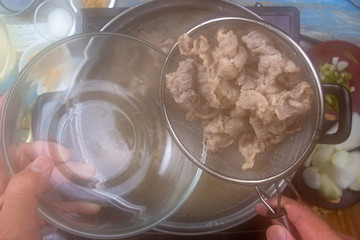 Chef scald beef with hot water  for cooking