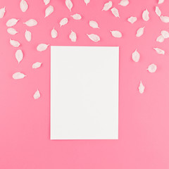 Flat lay of white postcard mock up with petals