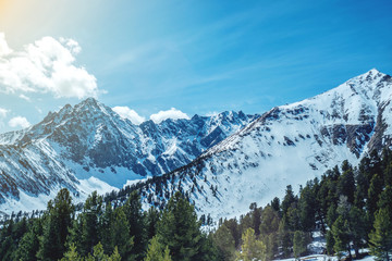 Landscape of snow-capped peaks of the rocky mountains in Sunny weather. Concept of nature and travel