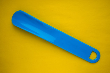 shoehorn on a yellow background