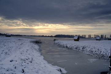 frozen lake in winter at sunset