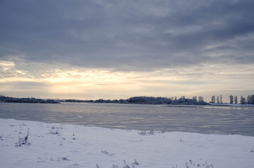 frozen lake in winter at sunset