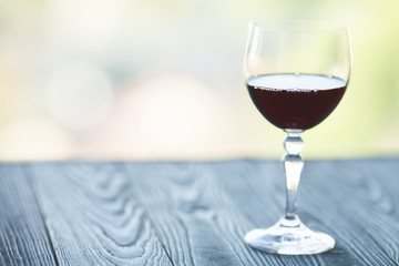 Wine glass in room among sunset window background