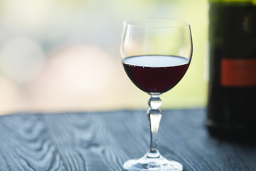Wine glass in room among sunset window background