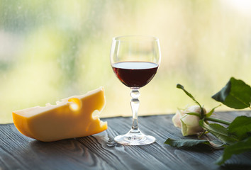 Glasses of red wine with food on table closeup