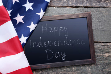 Fototapeta na wymiar American flag and wooden frame with inscription Happy Independence Day