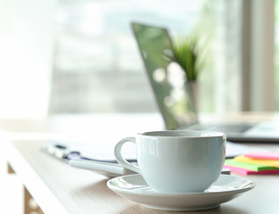 Top view desk of work table in office with laptop computer , notebook , calculator and a cup of coffee for creative business work or marketing plan to success planning of company