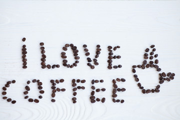 I Love Coffee phrase spelled out of roasted coffee beans isolated on white background