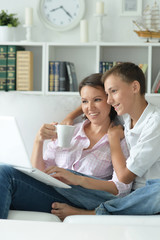 mother and son using laptop