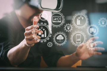 businessman wearing virtual reality goggles in modern office with Smartphone using with VR headset