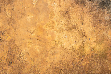 Old yellow cement surface with cracks and rough for the background.