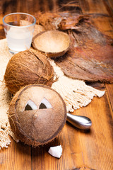 Big tropical palm nut coconut and coconut milk on wooden background close up