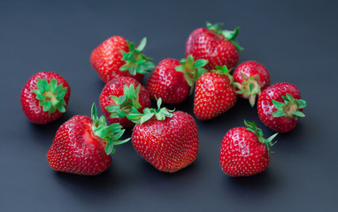 Fresh strawberry on dark background.
