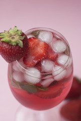 Homemade Delicious Red Sangria with Strawberry Ice Summer Drink Pink Background