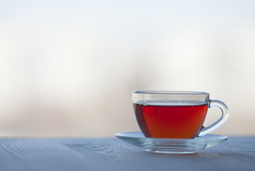 Black tea in glass cup. Isolated on white background