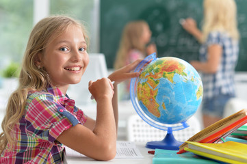 Fototapeta premium Teacher with two schoolgirls