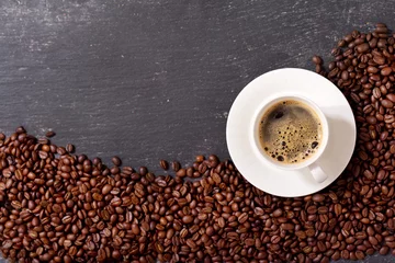 Fotobehang cup of coffee and coffee beans, top view © Nitr