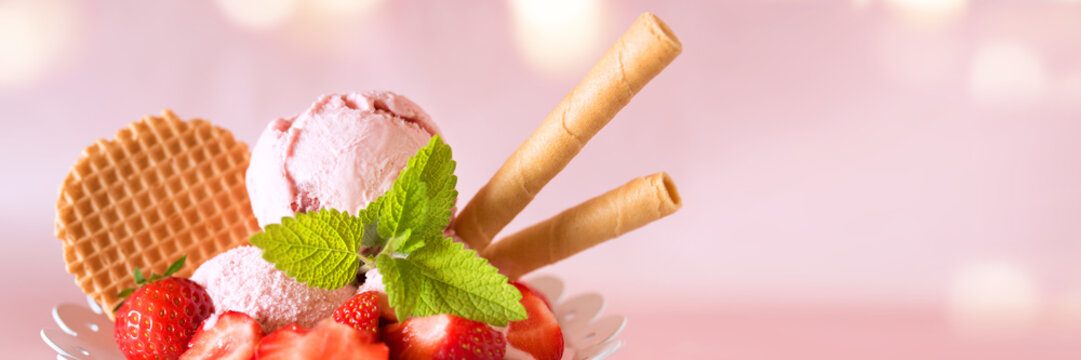 Ice cream cup with strawberries and waffle