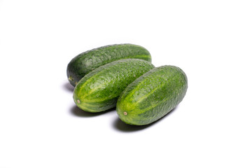 Fresh small green cucumbers close up copy space isolated on white background