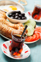 Traditional Turkish breakfast with fried eggs and tea