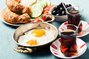 Traditional Turkish breakfast with fried eggs and tea