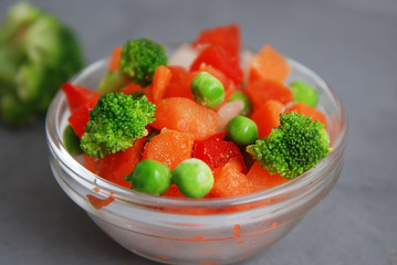 Frozen Colorful Vegan Healthy Vegetables. Brocolli, Carrots, Peas, Pepper. vertical Image. Gray...