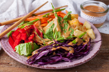 Vegetable salad with asian peanut coconut dressing