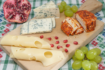 moldy cheese pepper cheese and emmental grapes assorted with pomegranate and grapes on wood cheese tasting delicacy concept