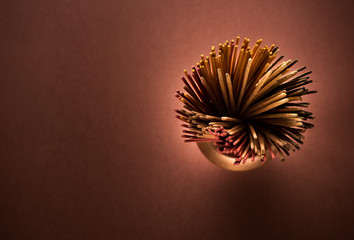 Incense aromatic sticks in a copper pot, top view
