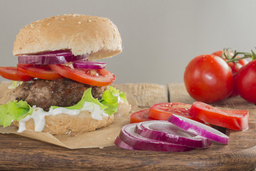 Delicious burgers with beef, tomato, cheese and lettuce