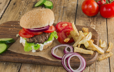 Delicious burgers with beef, tomato, cheese and lettuce