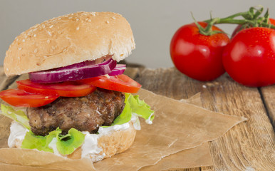 Delicious burgers with beef, tomato, cheese and lettuce