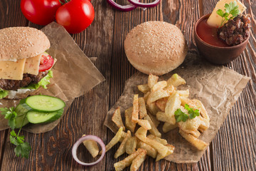 Delicious burgers with beef, tomato, cheese and lettuce