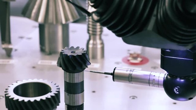 Operator inspection dimension metal parts by CMM after machining process in industrial factory.