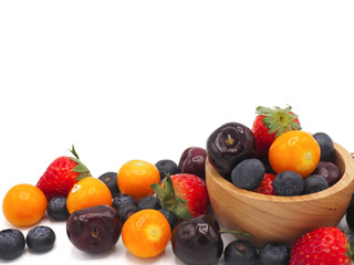 Fresh summer fruits, Cherry, strawberry, cape gooseberry and blueberry in wooden bowl isolated on white background.