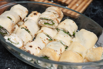 Pancake Rolles with Cheese Cream and Spinach Leaves. Preparing Food. Close up Food.