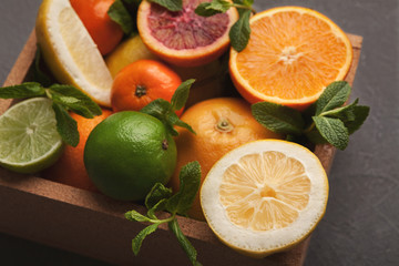 Variety of ripe citruses on gray background