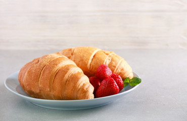 Croissants with strawberry on plate