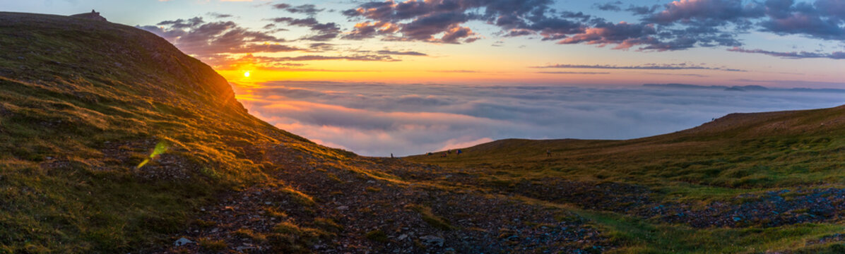 Sunset in the fog on the rocks of Soroya, Norway