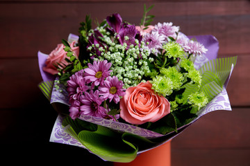 Modern bouquet of roses in rustic style, chrysanthemums, on wooden background