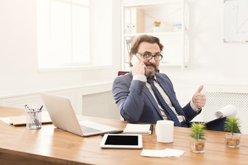 Serious businessman having phone talk