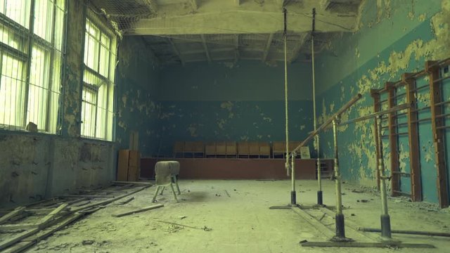 Abandoned gym hall in the school near to  Pripyat. Chernobyl nuclear disaster. Slider shot - Juni 2017: 30km Chernobyl, exclusion zone