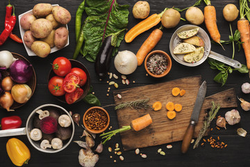 Fresh organic vegetables on wood background.
