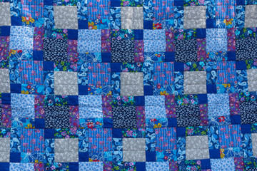 Fototapeta premium Made by hand from colored cloth fabrics, beautiful blankets. Patchwork. Needlework. Background.
