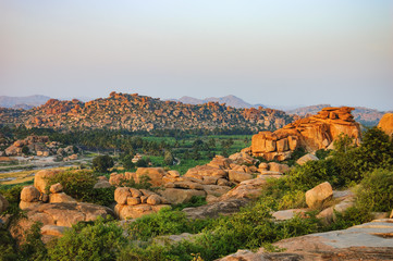 Picturesque view from the Malyavanta Hill at sunset overcast sky in Hampi, Karnataka, India.