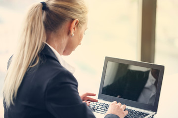 Business woman typing on laptop