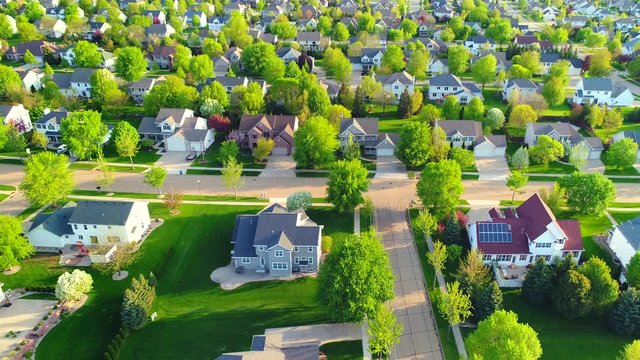 Beautiful neighborhoods, homes, Springtime aerial view at sunrise.
