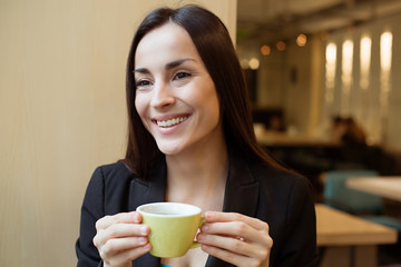 Happy gorgeous Business woman with cup of coffee during lunch time on coffee shop
