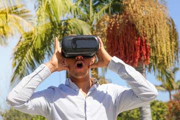 Men wearing virtual reality (VR) headset outdoor. Future world. Sunny summer in Los Angeles, VR world. Experimental reality